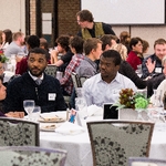 Audience members interacting at Symposium
